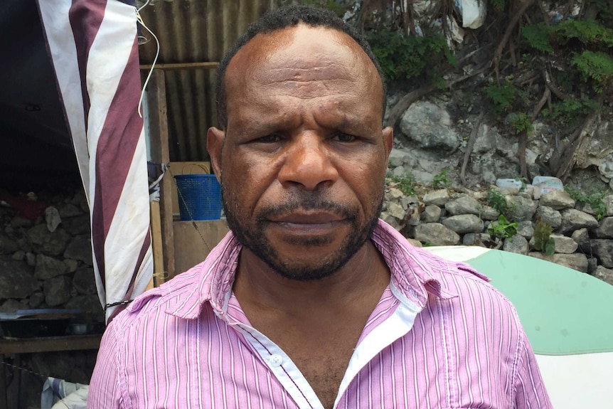 a man wearing a pink shirt