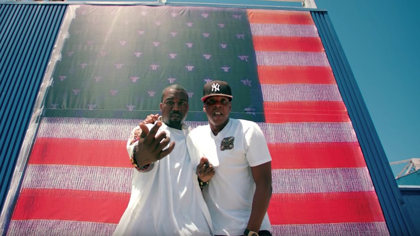Image of Kanye West and Jay Z in front of American flag