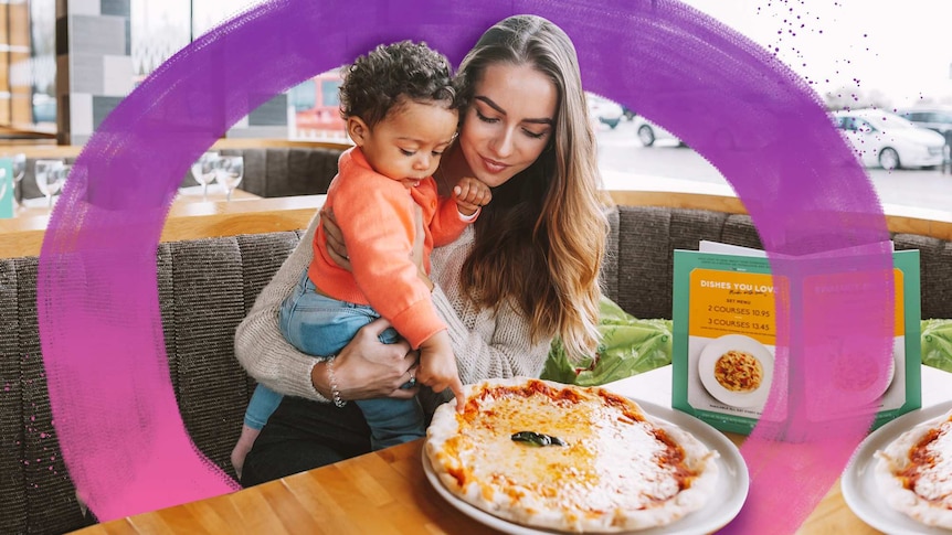 Mum with her toddler son in front of a pizza