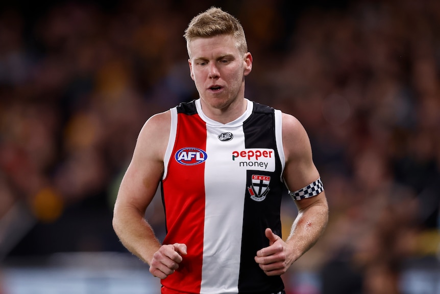 A St Kilda AFL player runs without the ball during a match against Hawthorn.