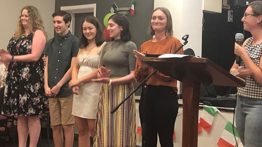 Six teenagers standing side by side