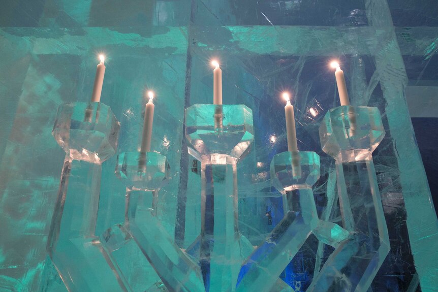 Candles in giant ice sculptures.