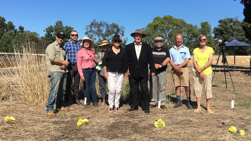 Nine people including members of the Hynam Heritage Group at the Hynam cemetery.