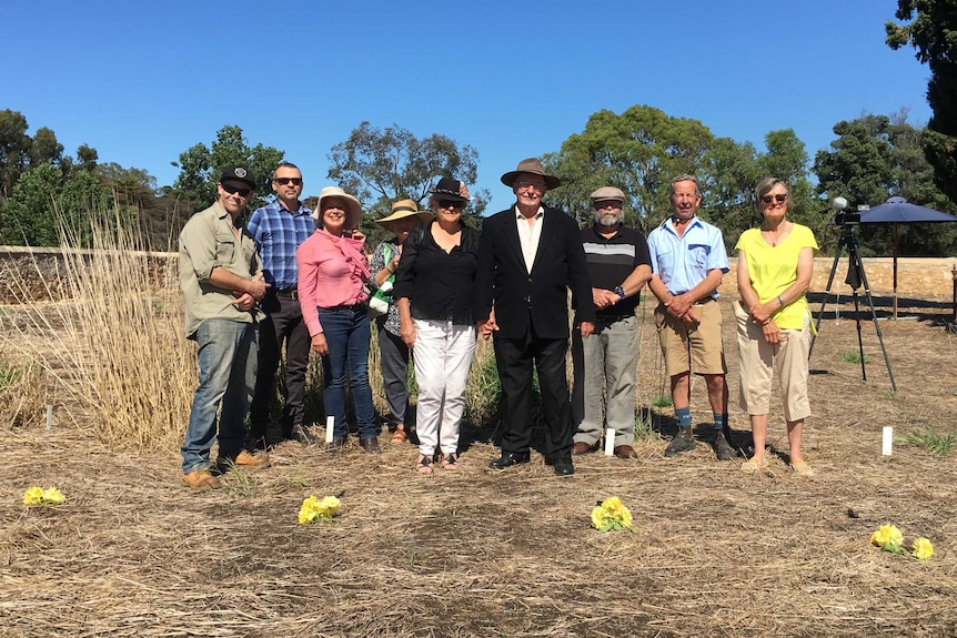 Nine people including members of the Hynam Heritage Group at the Hynam cemetery.