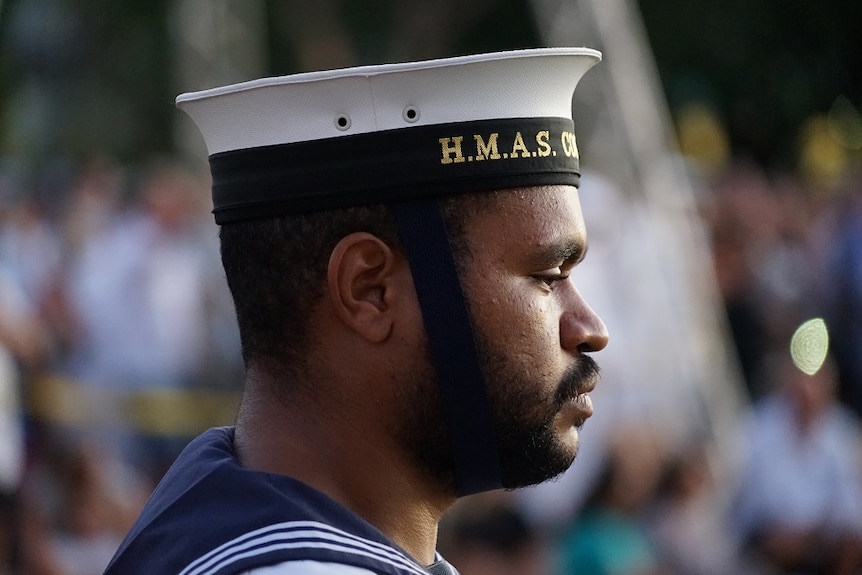 A close-up of a soldier face, side-on, at dawn