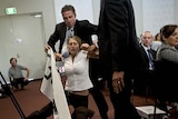 A protester is dragged out of the National Press Club in Canberra