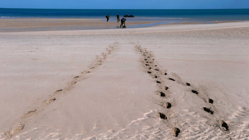 Soldiers from a NORFORCE patrol leave footprints in the sand.