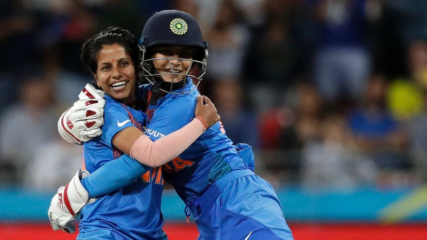 India bowler Poonam Yadav (left) and wicketkeeper Taniya Bhatia hug after a wicket in the T20 World Cup match against Australia.