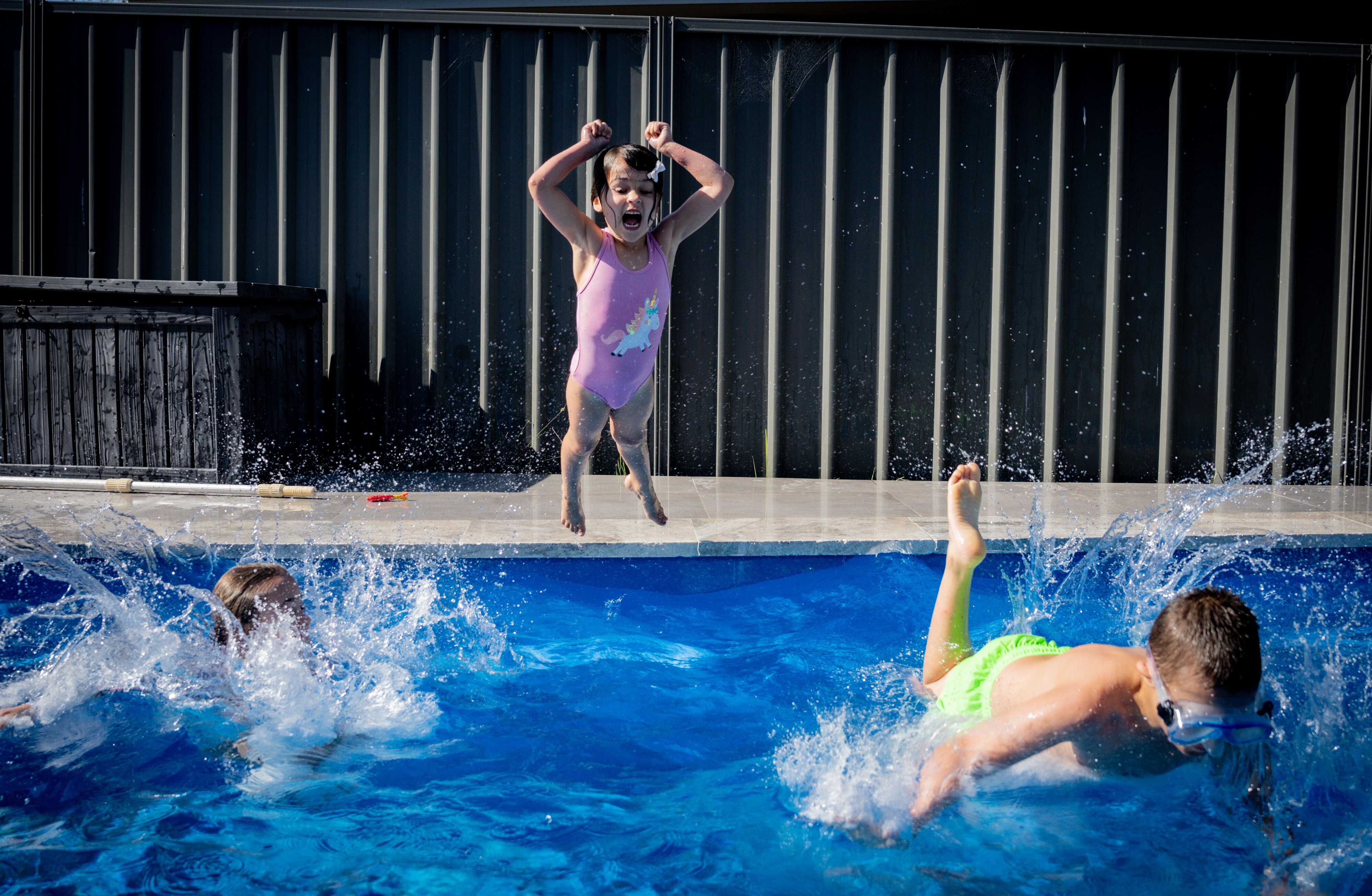 Jane's son jumping in the pool.