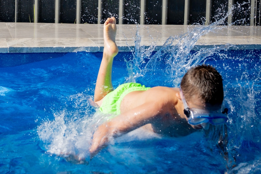 Jane's son jumping in the pool.