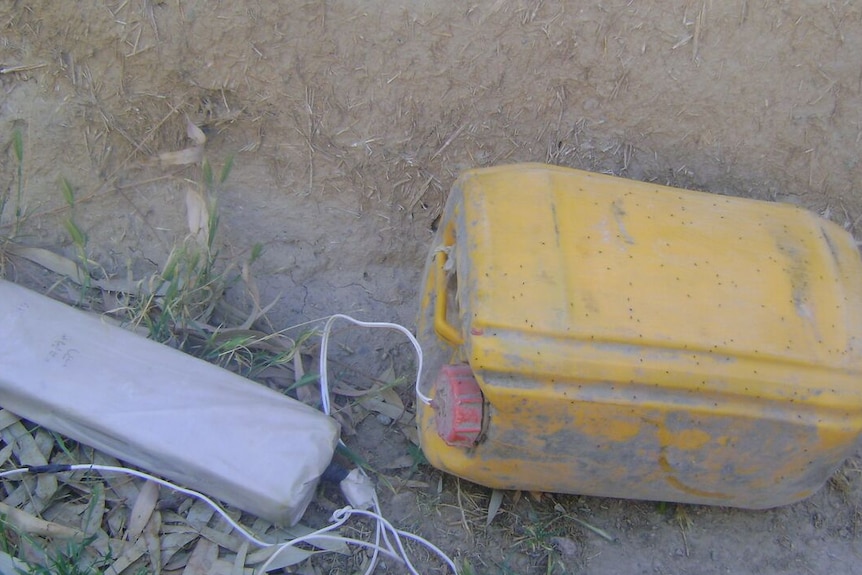 IED with pressure plate attached
