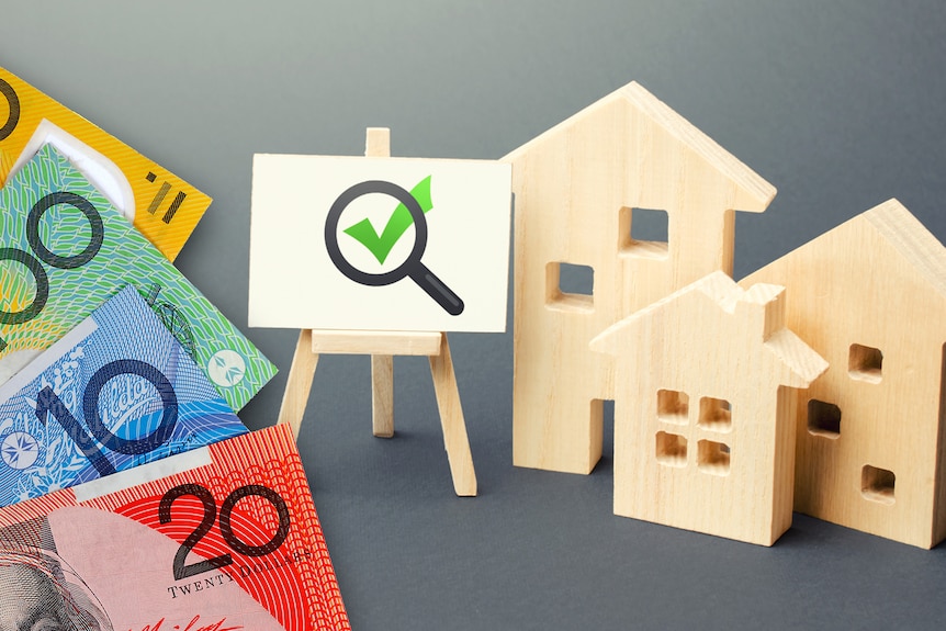A composite image showing cash, a tick on a sign, and wooden cut-outs of houses.