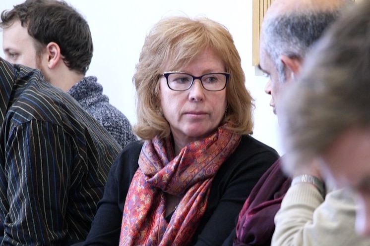 World Vision's regional leader in the Middle East, Conny Lenneberg, sits in court with other people.