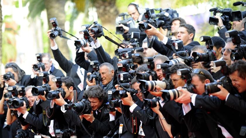 Photographers take photos during the arrival for the opening ceremony at the Cannes Film Festival