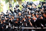 Photographers take photos during the arrival for the opening ceremony at the Cannes Film Festival