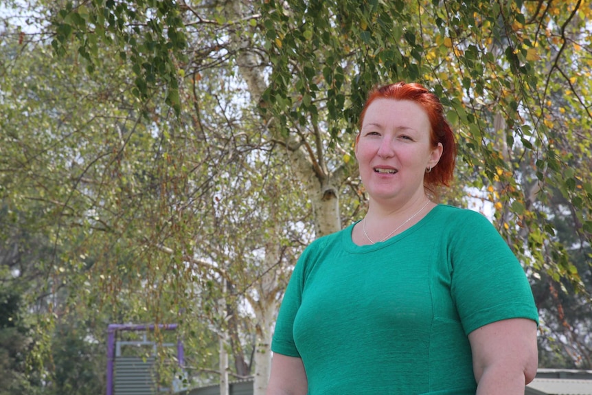 Kate Hurford standing outside in front of some trees.