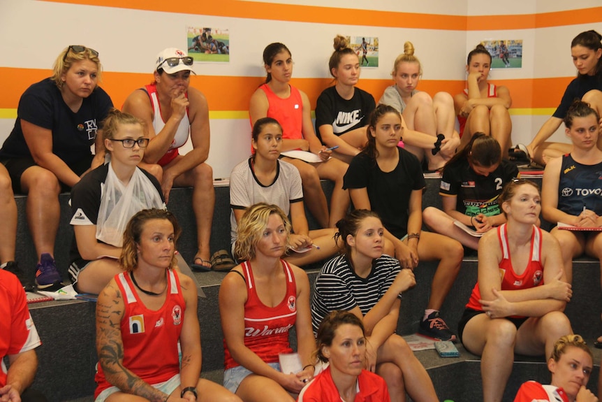 women sitting in a room and listening to someone speak