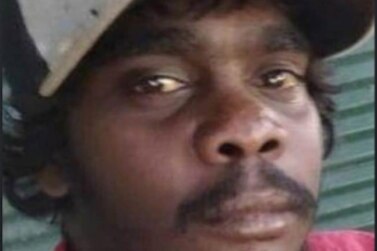 a close up shot of an Indigenous man with a hat