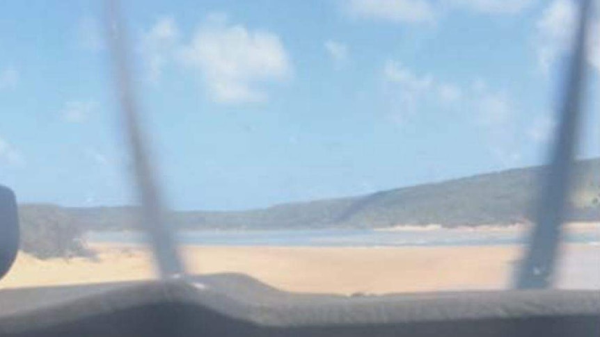 The image taken from the cockpit shows the beach as the plane nears impact. Its propeller can be seen spinning.