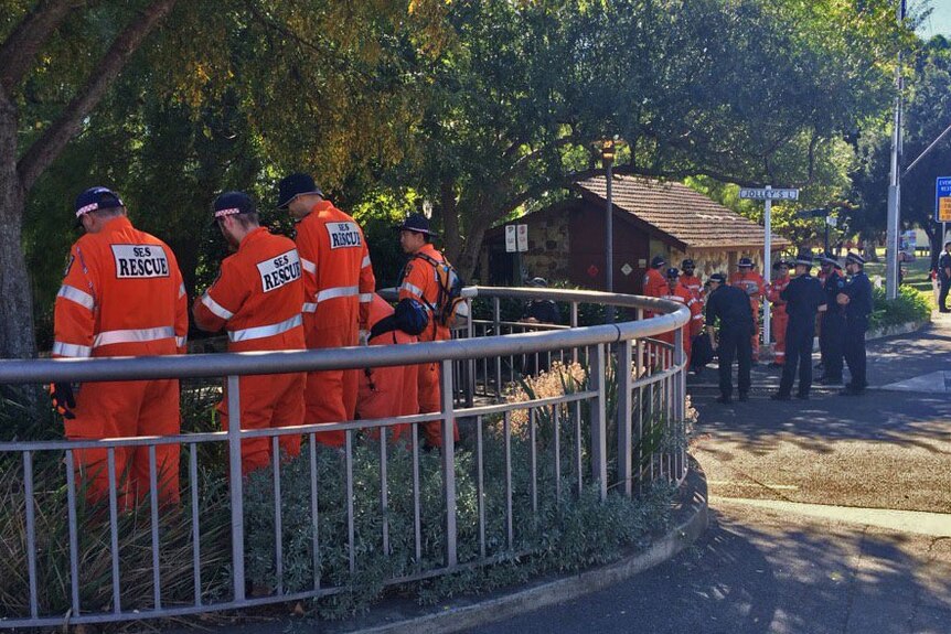 Police and SES volunteers search the Torrens and its banks the day after a body was retrieved