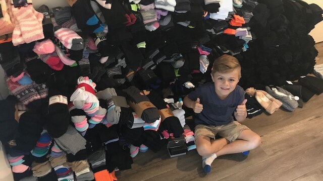 Six year old Harper-Roy has collected more than 1600 pairs of socks for the homeless