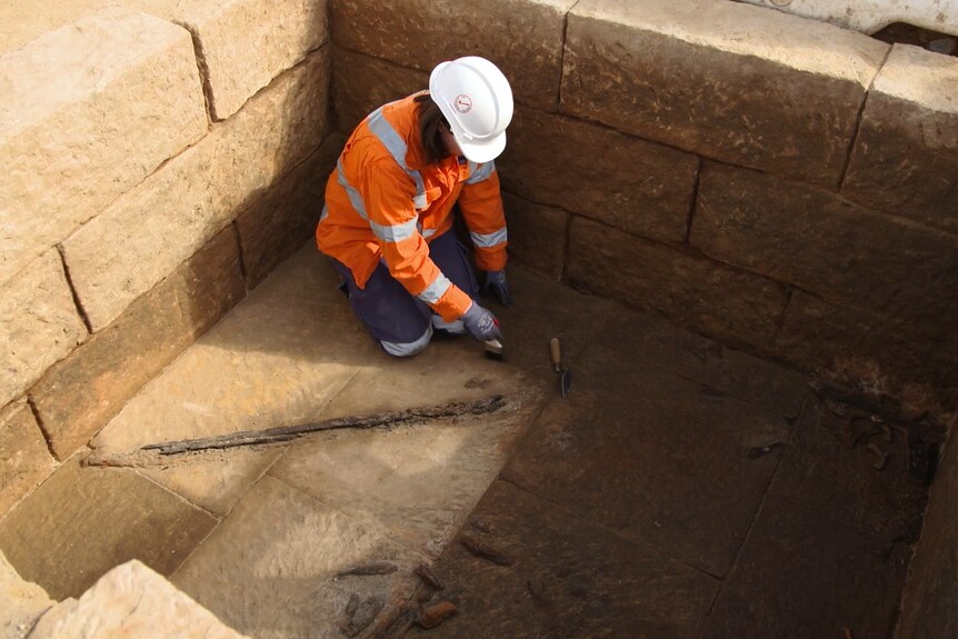 worker uncovers part of vault floor