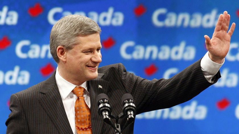 Conservative Party leader and Canadian Prime Minister Stephen Harper gestures to supporters