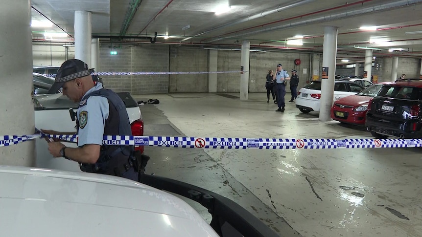 NSW Police in a gym car park putting up tape