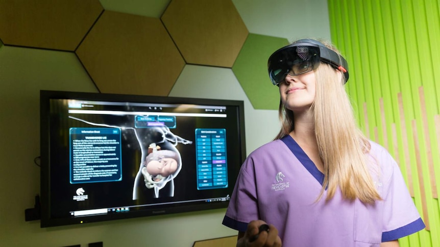 A woman wearing a black electronic headband over her eyes looks into the distance.