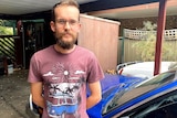 Adelaide man Sam Jefferies stands under a porch.