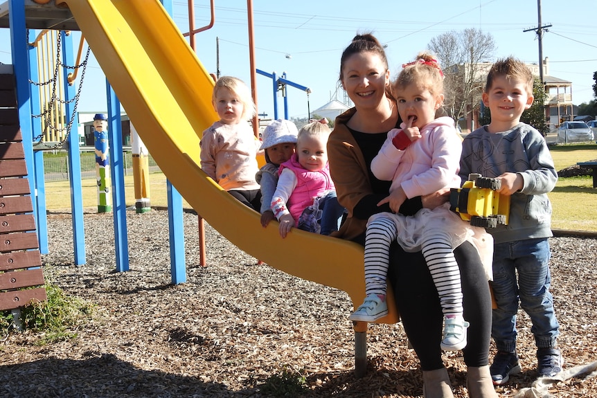 A photo of kids and a mum on a slide 