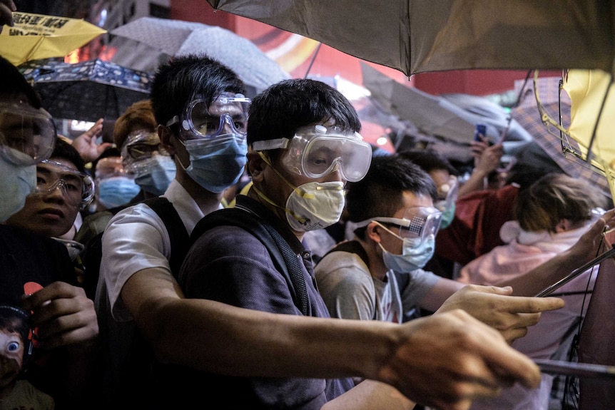 Pro-democracy protesters wear face masks to protect them from pepper spray