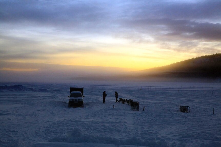 Dog sleds prepare for a morning run over the frozen waters of the Torne river.