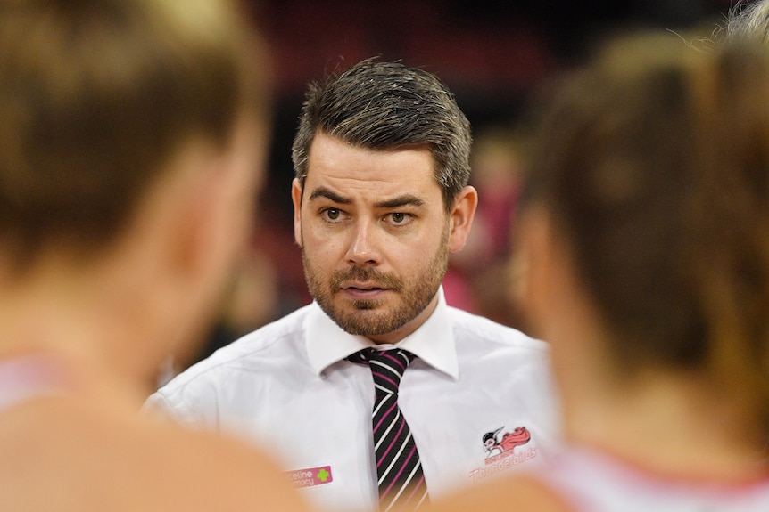 Dan Ryan addresses his players in a huddle during a Thunderbirds game