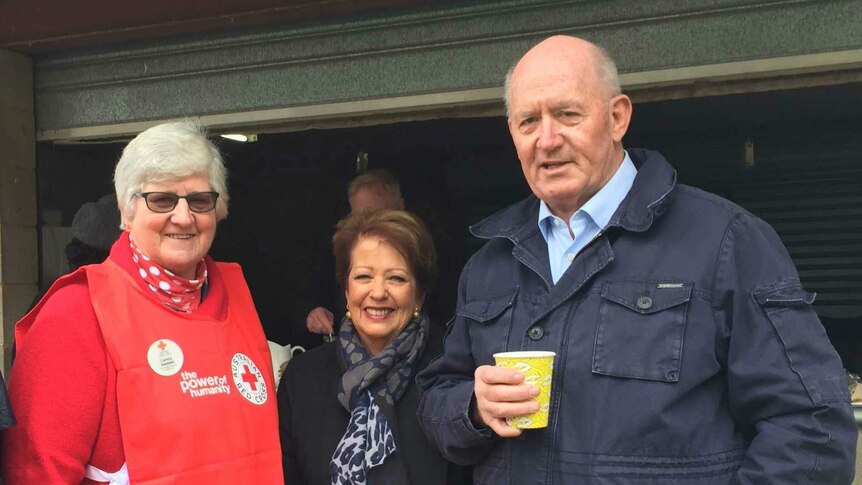 A Red Cross volunteer meets the Governor-General and his wife