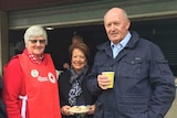 A Red Cross volunteer meets the Governor-General and his wife