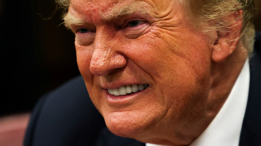 A close-up view of Donald Trump's face as he seems to grimace.