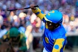 Victor Espinoza celebrates as American Pharoah wins Kentucky Derby