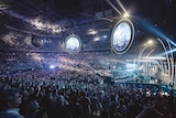 Lighting and music draw thousands of people for a Hillsong service.