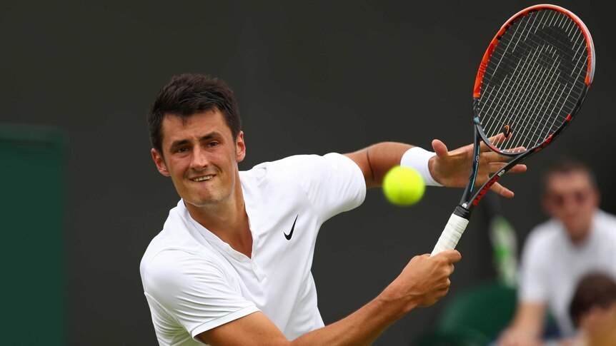 Australia's Bernard Tomic plays a backhand against Moldova's Radu Albot at Wimbledon 2016.