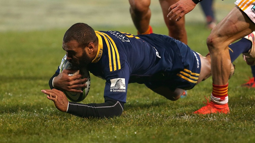 Try time ... Patrick Osborne dives over to score for the Highlanders