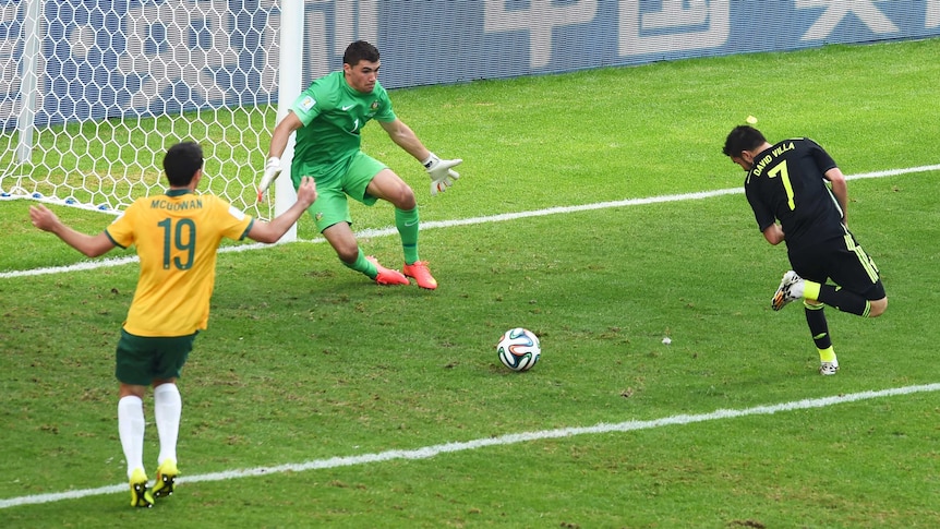 David Villa of Spain scores with a back heel past Mathew Ryan