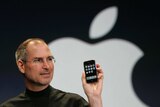 Apple CEO Steve Jobs holds up the new iPhone in 2007