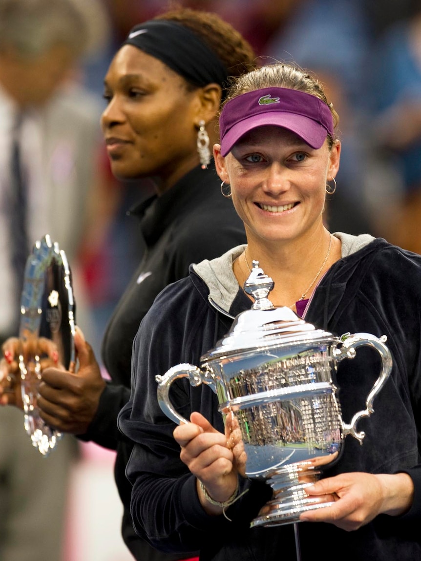 Samantha Stosur and Serena Williams hold their trophies after the US Open singles final