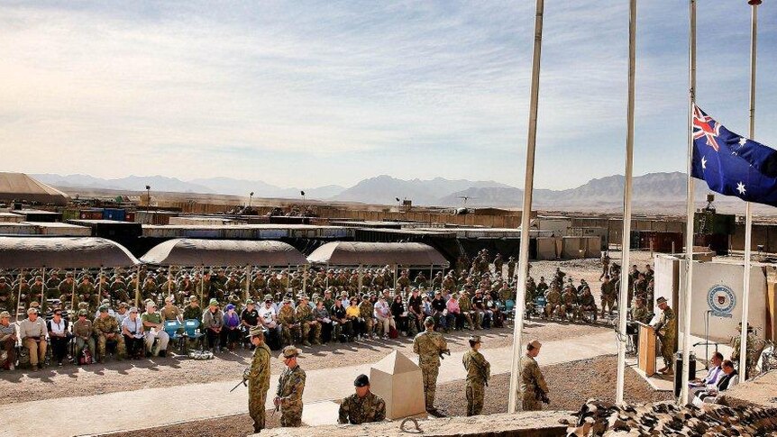 Australian families attend a memorial service for their loved ones during a secret visit to Afghanistan