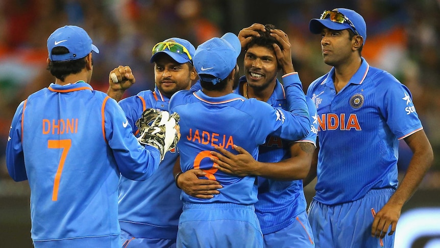 Easy win ... India's Umesh Yadav is congratulated by team-mates after taking the wicket of Mushfiqur Rahim