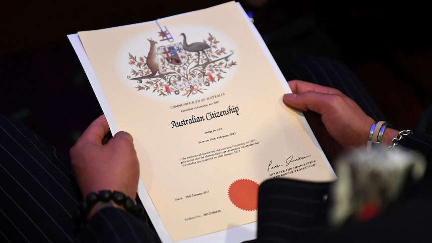 A close up of an Australian Citizenship document from 2017 in the hands of a new citizen.