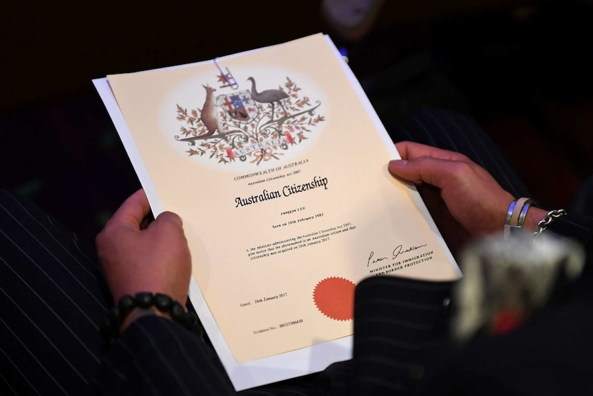 A close up of an Australian Citizenship document from 2017 in the hands of a new citizen.