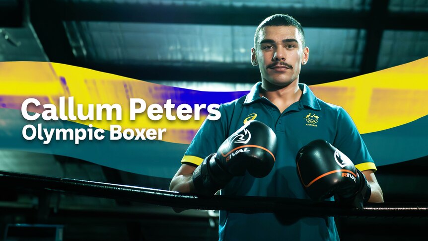Callum Peters poses for the camera wearing gloves leaning on a boxing ring rope.