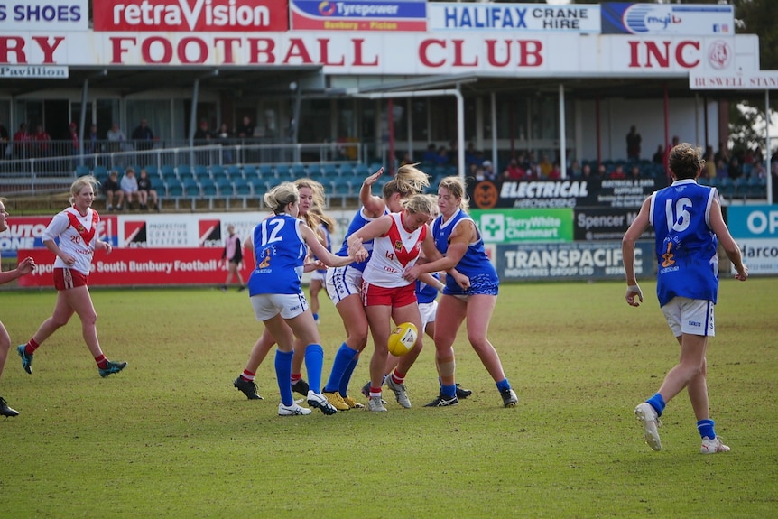 A group of girls playing a game of football